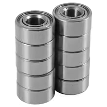 Two stacks of metal bearings on a white background
